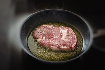 fresh cooking at home -grilled beefsteak with salt and pepper in olive oil