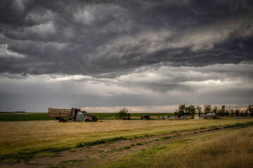 Old, abandoned vehicles on the Great Plains as Severe Weather Approaches