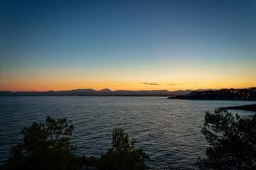 Fototapeta na wymiar A beautiful sunset in a coast of Salou (Spain) with a blue sky and rocks