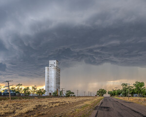 Old, abandoned grain elevators on the Great Plains with Dramatic Clouds