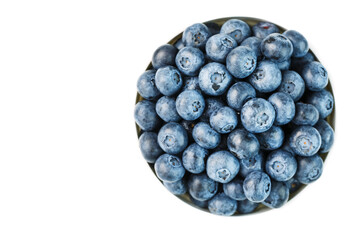 Juicy and ripe Blueberries in a white plate on a white background