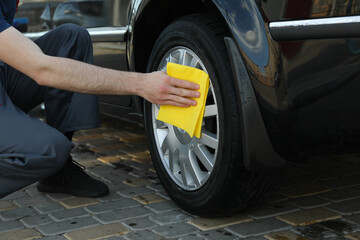 A man rubs a car. Car wash. Clear car concept