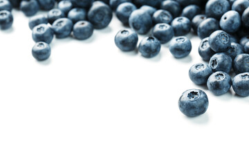 Blueberries isolated on a white background. A scattering of ripe, juicy, delicious and healthy berries.