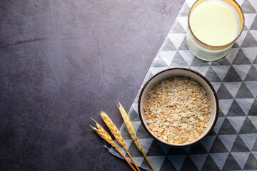 uncooked oats flakes black background, top down 