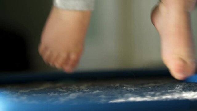 Baby Jumps In A Exercise Bouncer, Slow Motion Closeup
