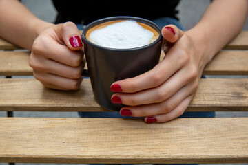 Fototapeta na wymiar Hand holding coffee cup, selective focus