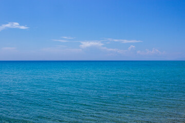 Views of the sea from the beach, the sea is azure blue, as is the sky. Copy space.