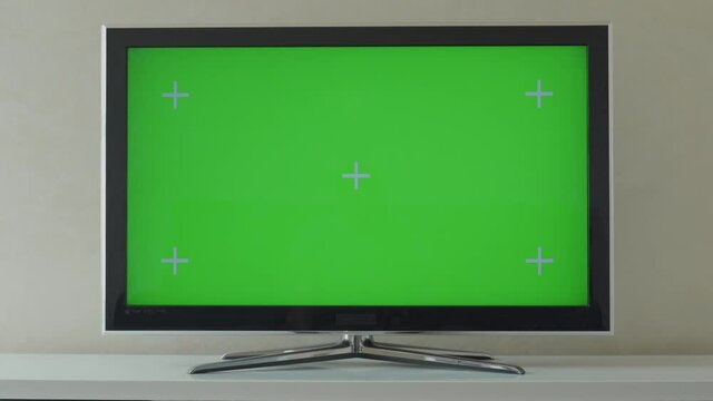 Zoom Out Shot of a TV with Horizontal Green Screen Mock Up. Living Room at Home.