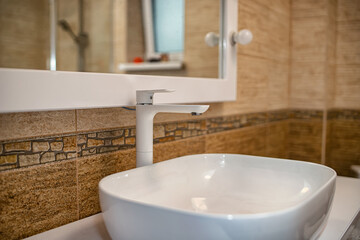 The interior of the bathroom with a big illuminated mirror