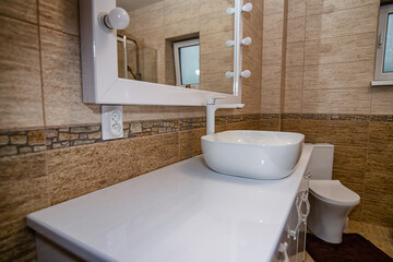 The interior of the bathroom with a big illuminated mirror