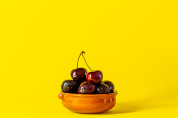 Cherries on a yellow background. Concept of healthy food and fruit.