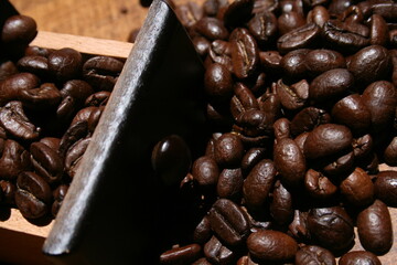 Tasty cup of coffee along with coffee beans and grinder