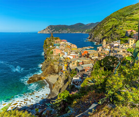 A view from the path leading towards Corniglia over the colourful village of Vernazza, in the summertime