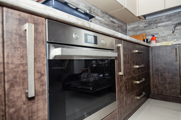 Modern kitchen interior in wenge colors with built-in appliances