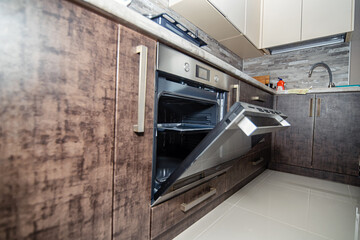 Modern kitchen interior in wenge colors with built-in appliances