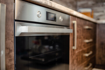 Fototapeta premium Modern kitchen interior in wenge colors with built-in appliances