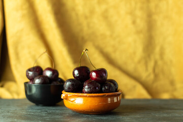 Cherries on a yellow autumn cloth. Concept of healthy food and fruit.