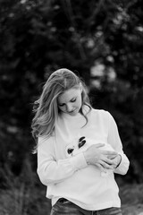 black and white photo of a teenage girl holding a white rabbit