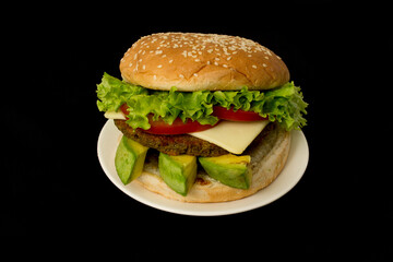 Delicious hamburger on black background.