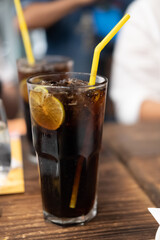 Soft drink with ice and lemon slice inside glass