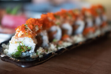 California roll topped with fresh salmon and salmon roe served on crispy shrimp.