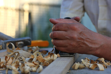 carpenter's hands at work on wood processing