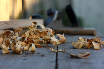 view of the desktop in the carpenter's shop. Wood shavings and carpenter's tools