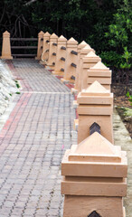 Small pillars arranged in a row on the edge of the canal.