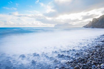 Ocean, clouds and rocky mountains