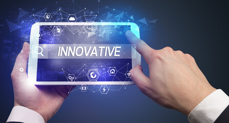 Close-up of a tablet searching INNOVATIVE inscription, hi-tech computing concept