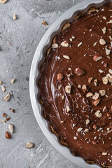Delicious hazelnut chocolate tart, topped with nuts