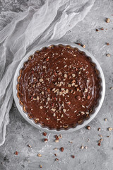 Delicious hazelnut chocolate tart, topped with nuts