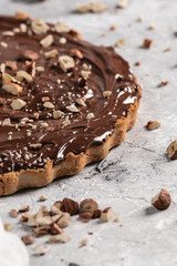 Delicious hazelnut chocolate tart, topped with nuts