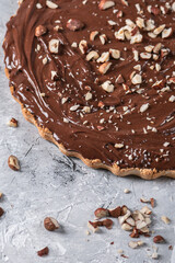 Delicious hazelnut chocolate tart, topped with nuts