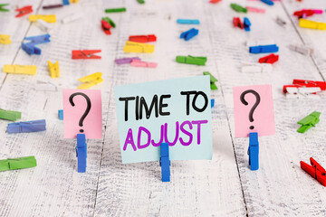 Text sign showing Time To Adjust. Business photo showcasing making necessary or desirable changes to corresponding Scribbled and crumbling sheet with paper clips placed on the wooden table