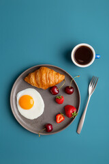Minimal breakfast at blue background