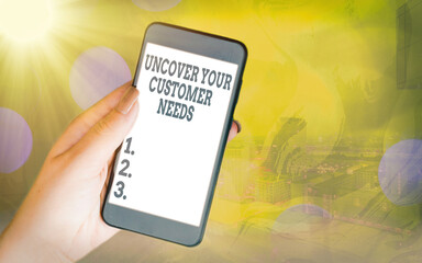 Handwriting text Uncover Your Customer Needs. Conceptual photo reveal product and present solution to consumer Modern gadgets with white display screen under colorful bokeh background