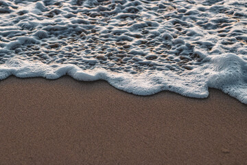 wave foaming at shore