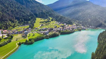Aerial view of Auronzo Lake and Town in summertime, italian dolomites