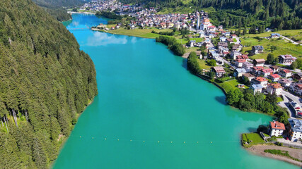 Fototapeta premium Alpin lake and dam in summertime, view from drone, Auronzo, italian dolomites
