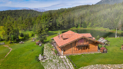 Fototapeta na wymiar DANTA, ITALY - JULY 2020: Alpin restaurant over the lake in summer season, aerial view