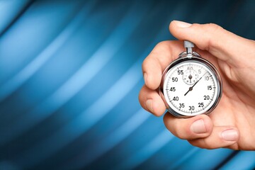 Silver classic stopwatch in human hand