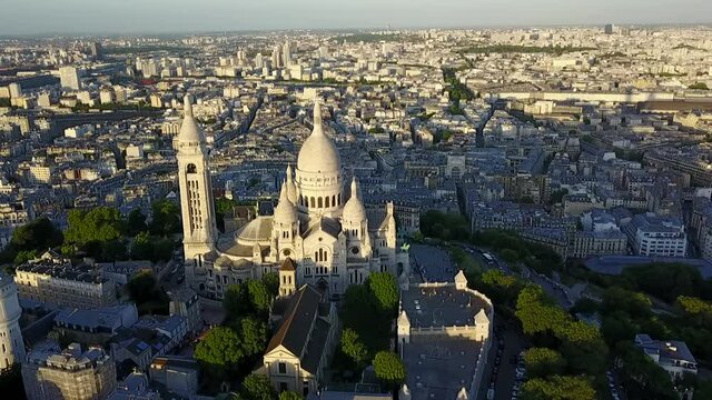 AERIAL: Sacre Coeur Chruch Cathedral on Hill in Paris evening light, Summer
