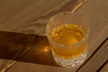 whiskey with ice on a wooden table