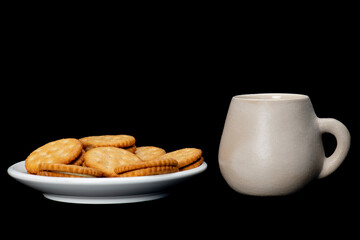 white plate with lemon cookies with cup of coffee