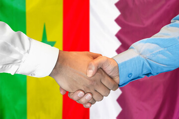 Handshake on Senegal and Qatar flag background. Support concept.