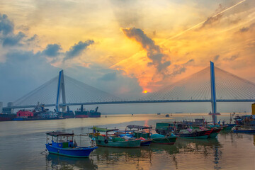 A bridge crosses the sea at sunrise and sunset in hainan, China.