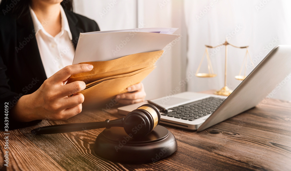 Wall mural business and lawyers discussing contract papers with brass scale on desk in office. law, legal servi