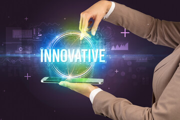 Close-up of a touchscreen with INNOVATIVE inscription, new technology concept