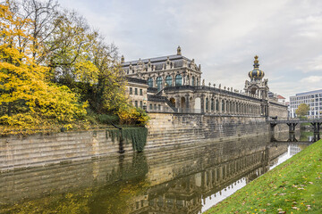 Fototapeta na wymiar Colorful autumn view of Zwinger from channel. Zwinger Palace was royal palace XVII century in Dresden, Germany. 
